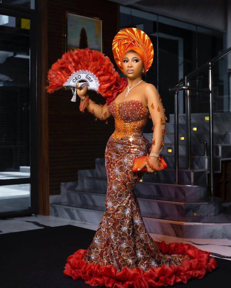 Orange & Copper Sequin Mermaid Asoebi with Red Ruffle Train | Nigerian Wedding Drama | OutfitLibrary