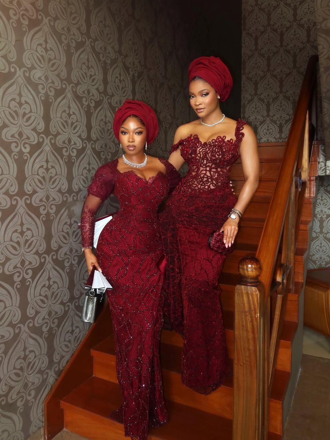 Wine Burgundy Asoebi Duo: Beaded Lace vs Cord Embroidery Gown on a Staircase | OutfitLibrary