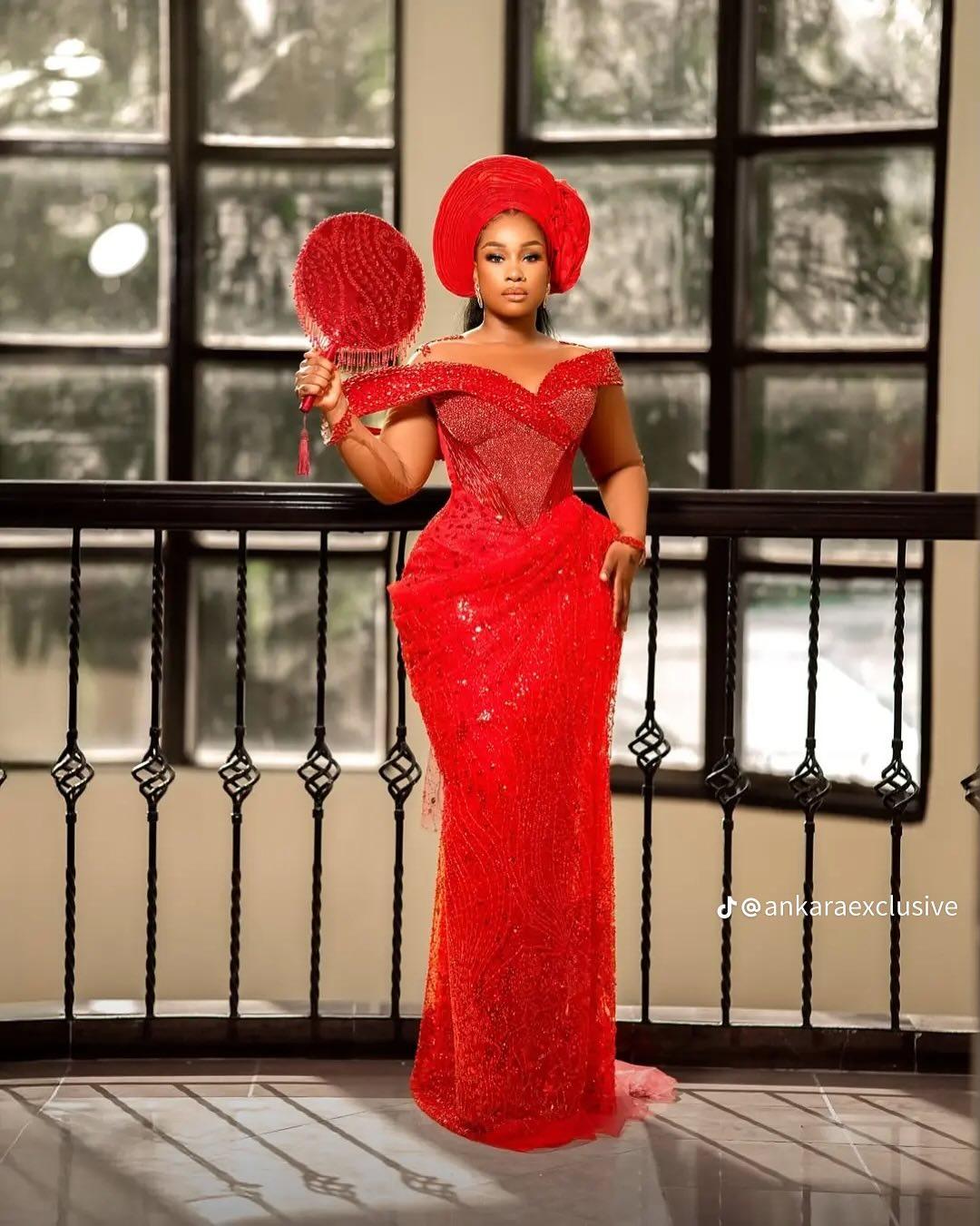 Red All-Over Lace Asoebi with Off-Shoulder Draped Neckline & Beaded Feather Fan | OutfitLibrary