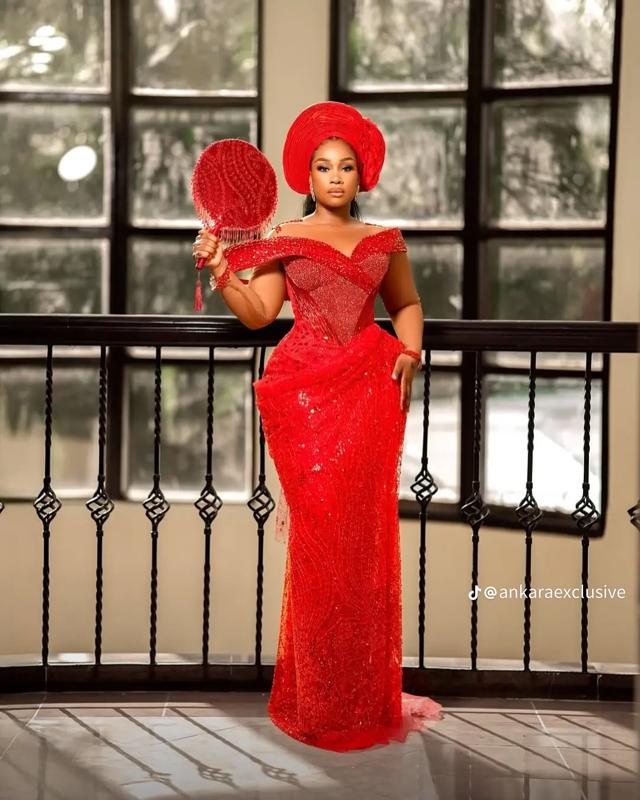 Red All-Over Lace Asoebi with Off-Shoulder Draped Neckline & Beaded Feather Fan | OutfitLibrary
