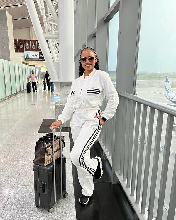 Victoria Uvo Masters Airport Chic in White Tracksuit with Black Stripes | OutfitLibrary.com