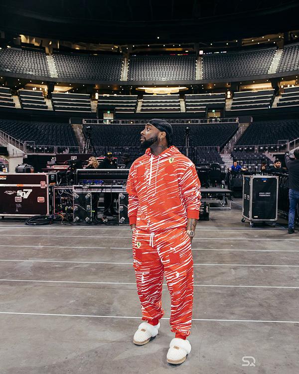 Davido in Orange Ferrari Tracksuit & Fuzzy Slides at State Farm Arena | OutfitLibrary.com