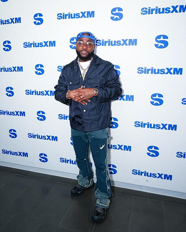 Davido in Navy Nylon Jacket & Distressed Denim at SiriusXM New York | OutfitLibrary.com