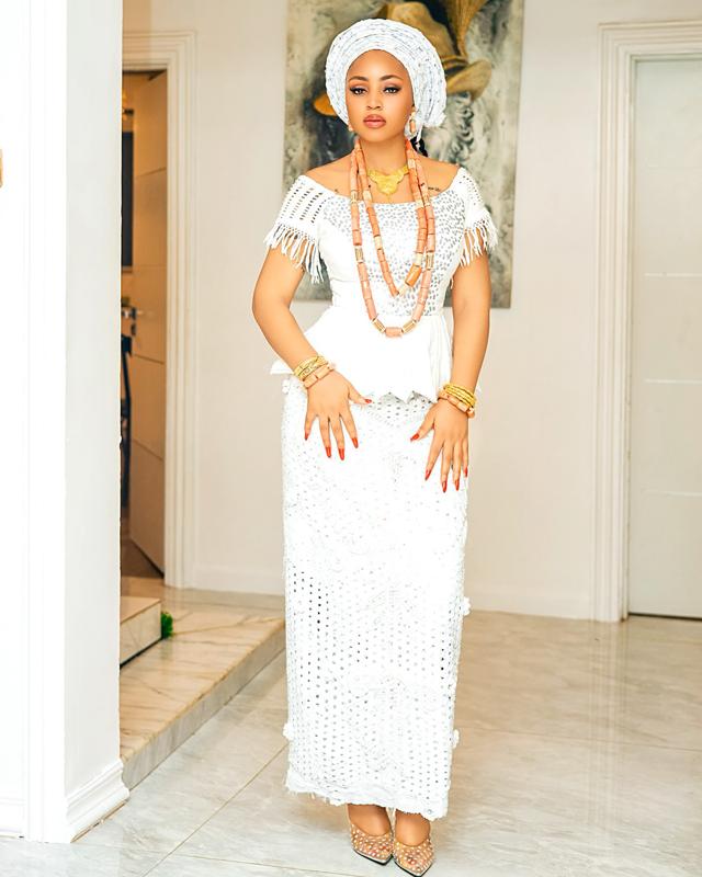 Regina Daniels in All-White Lace Traditional Look with Gele & Coral Beads | OutfitLibrary.com