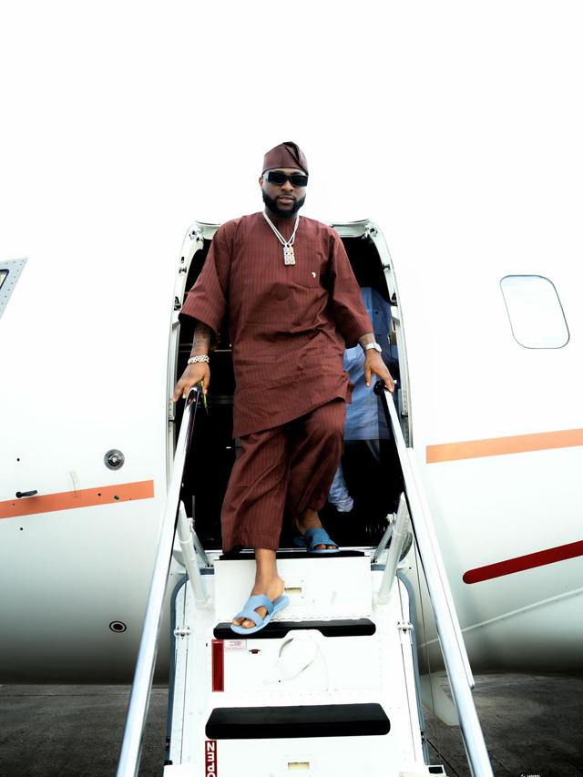 Davido Lands in Effortless Brown Kaftan Set & Slides at Private Jet Arrival | OutfitLibrary.com