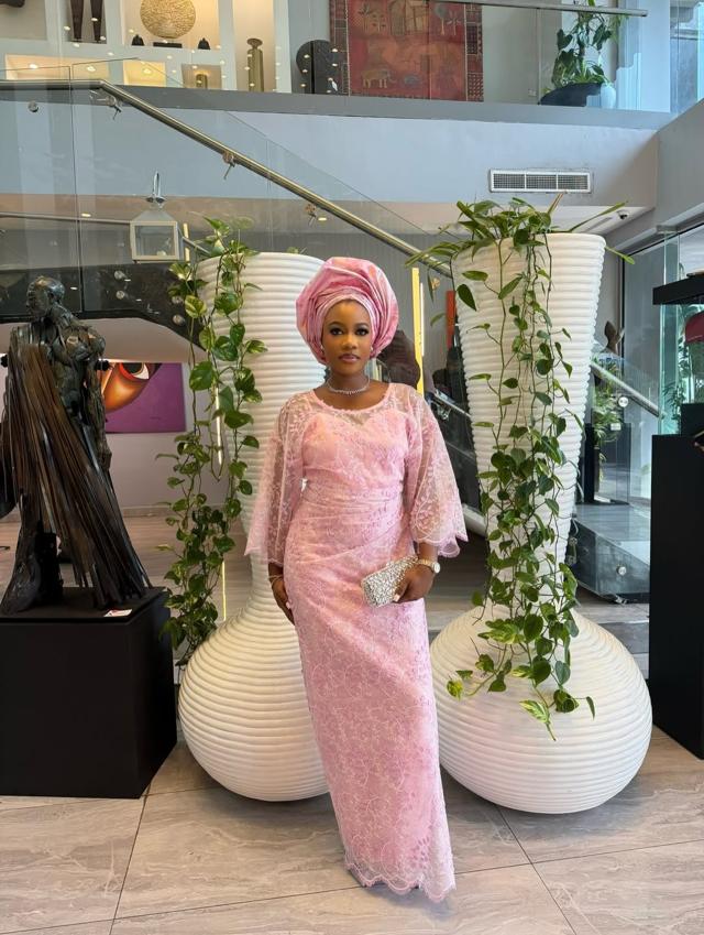 Blush Pink Allover Lace Cape-Sleeve Asoebi with Silver Clutch in Art Gallery Setting | OutfitLibrary